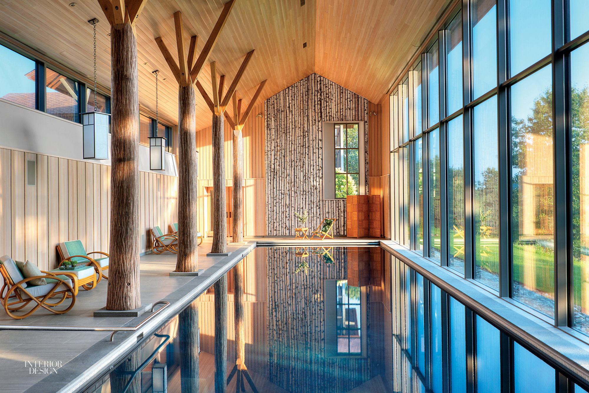 To bring the outdoors in, this cathedral ceiling in an indoor pool house seems to be supported by wooden trees