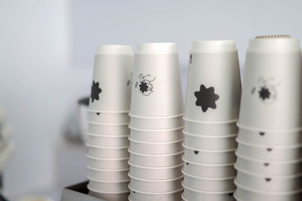 the branding includes white cups with black designs