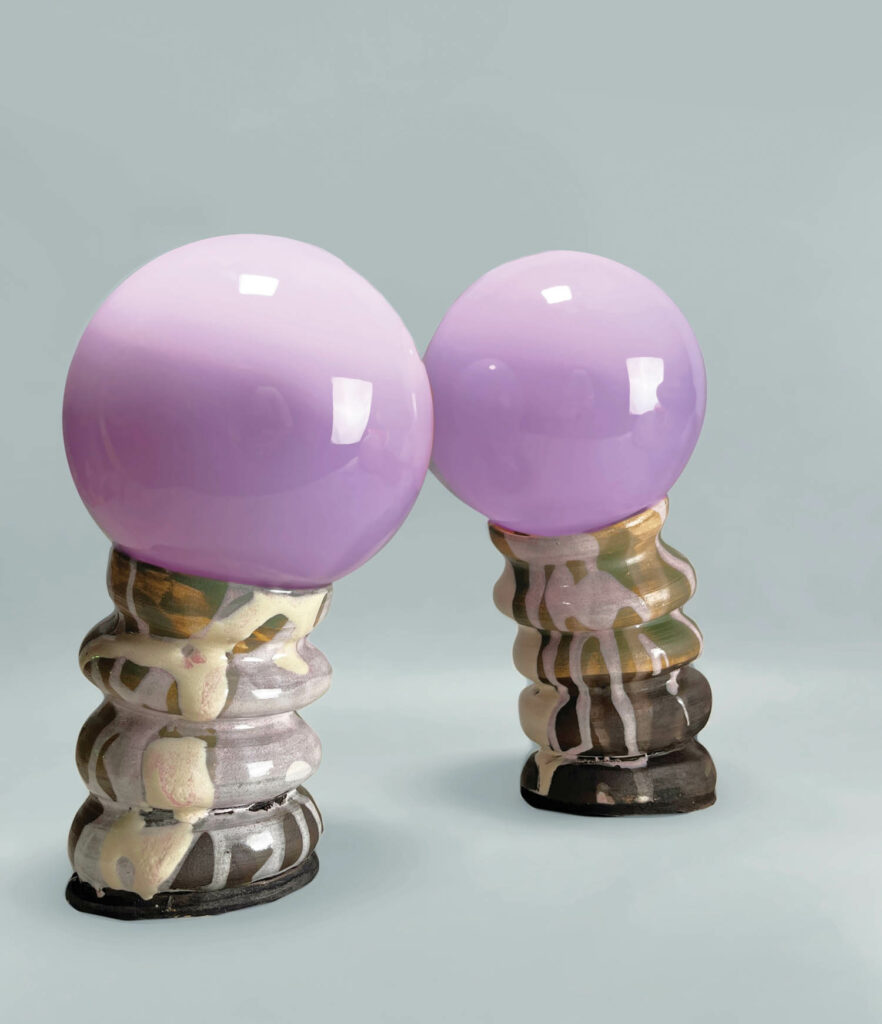 contour lamps with purple globes on top of a ceramic base