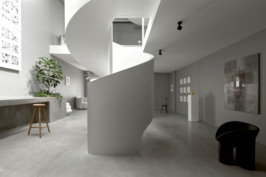 A sculptural white winding staircase