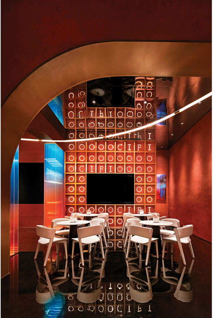 a seating area awash in hues of deep red in le bar