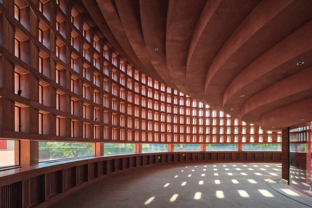 red travertine slabs have square cutouts that let the light into this museum