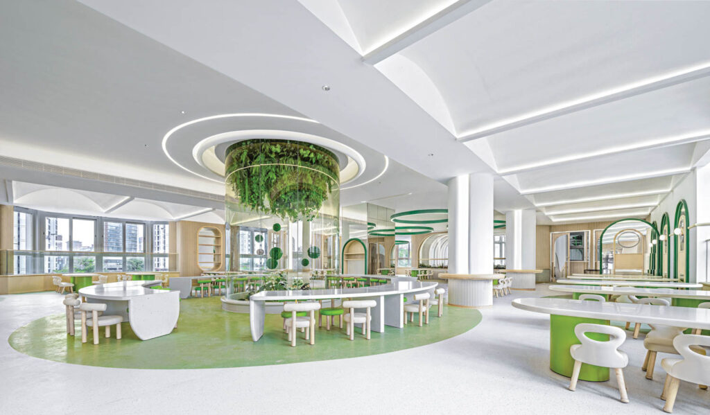 greenery hangs from the ceiling in this student space at a kindergarten school