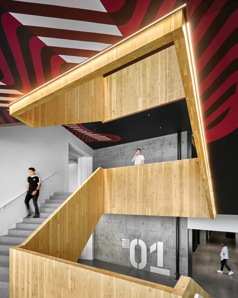 a circling wooden staircase inside Adidas headquarters