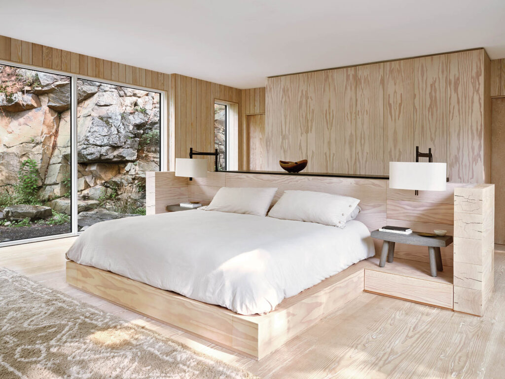 a cozy bedroom with views of a rocky landscape