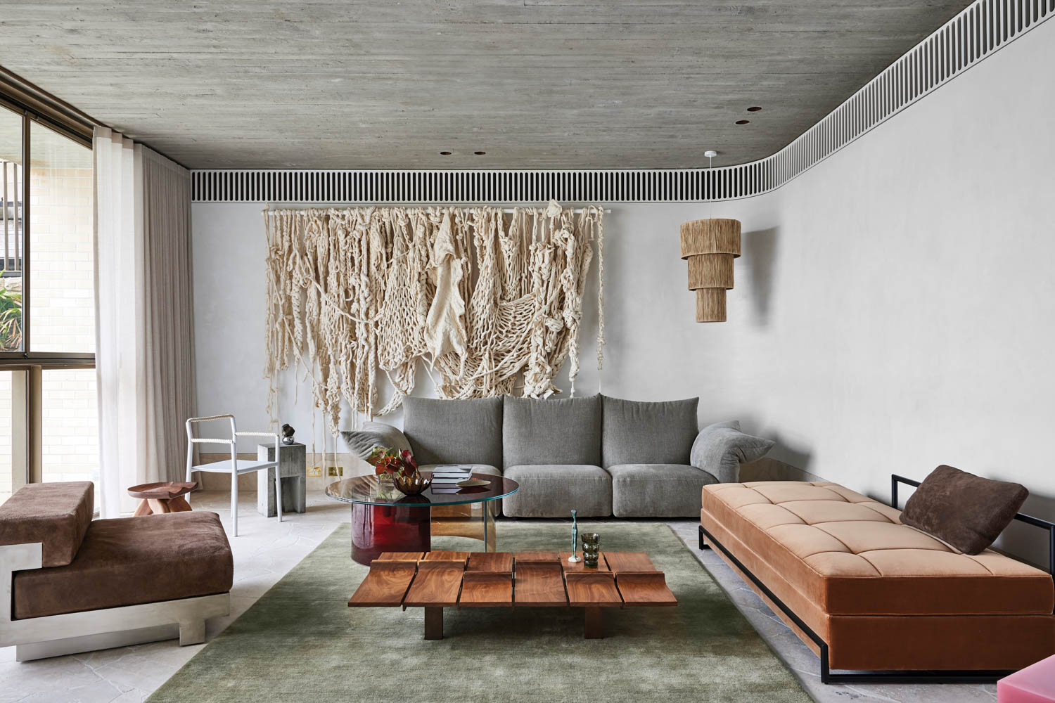 the cabana sitting area of this Sydney home, filled with artwork and several seating options