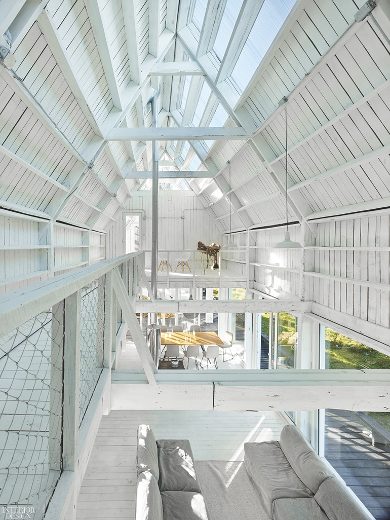 A bright and airy white wooden cathedral ceiling painted white lets the sunlight in