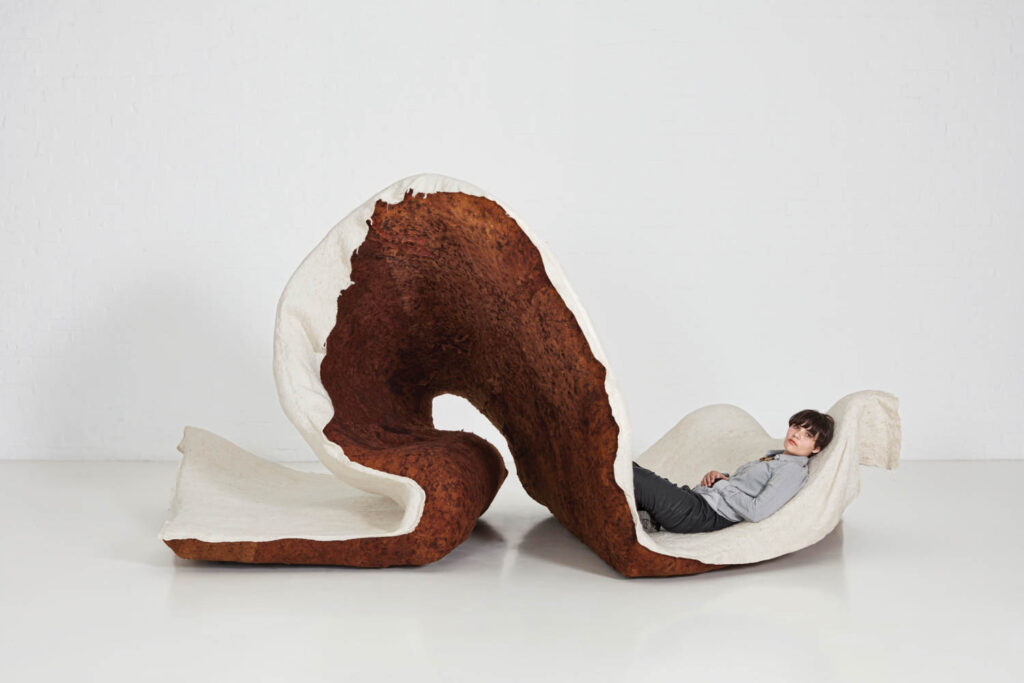 a felted sculpture curls up like an inch worm