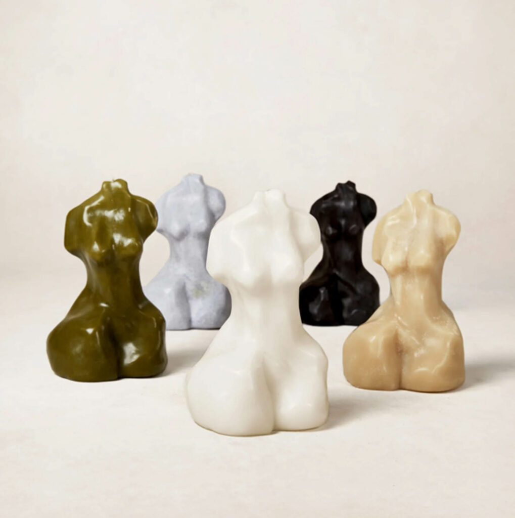 a collection of candles in the shape of a woman's body