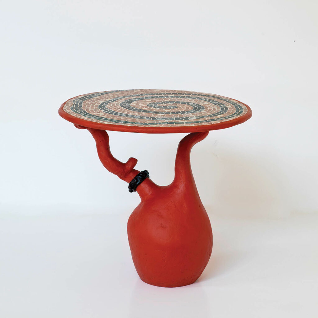a red biomorphic table with a swirling pattern top