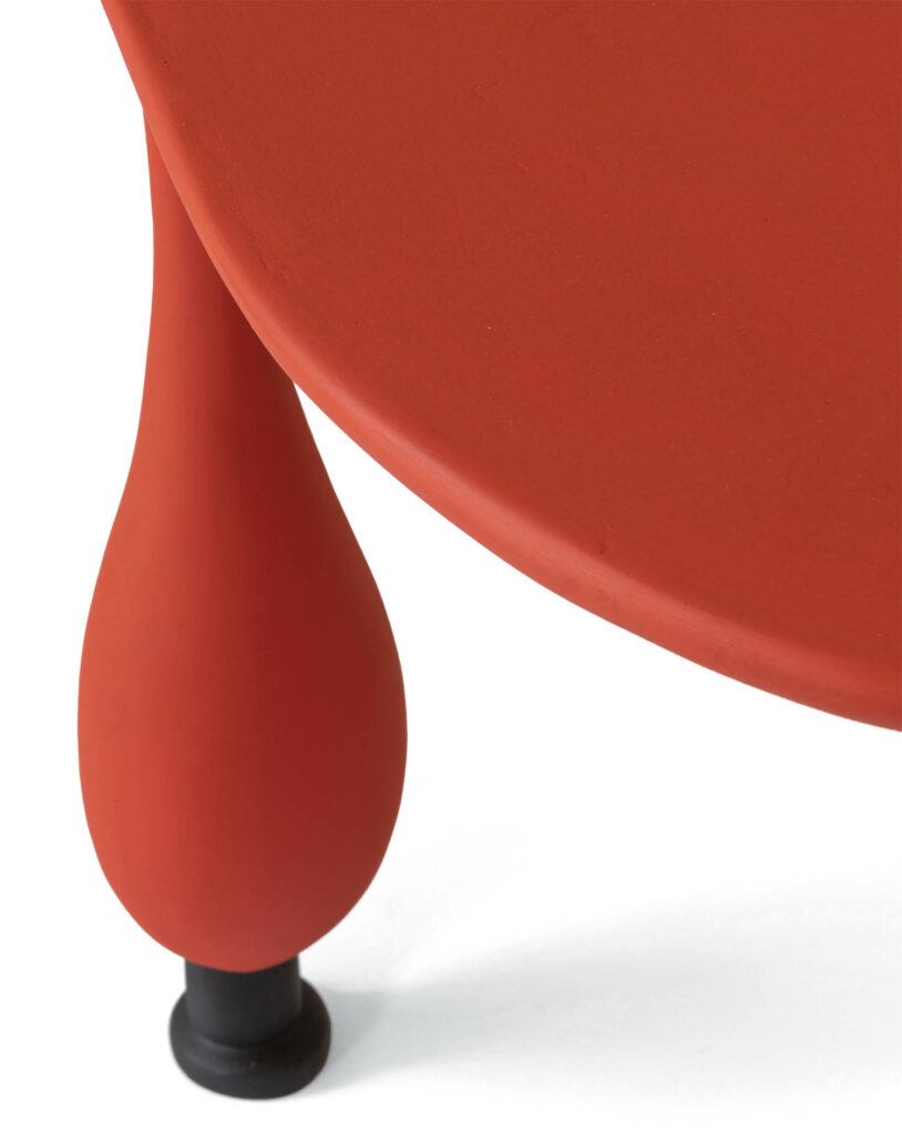detail of a bulbous red table leg
