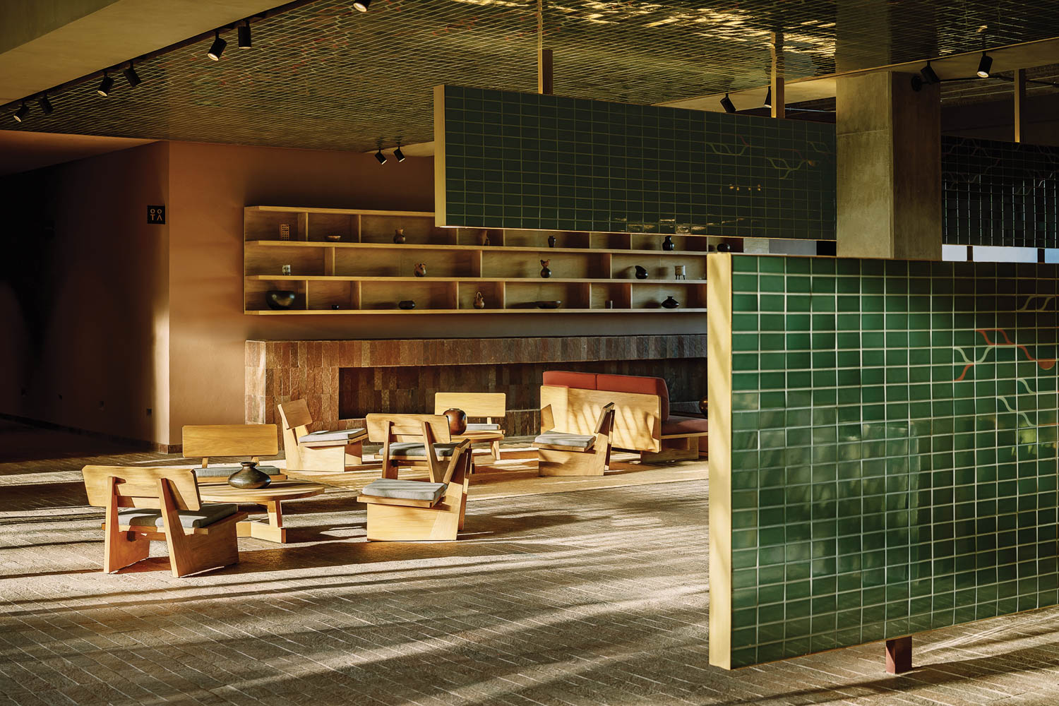 green tile partitions in a public space within a Hilton hotel