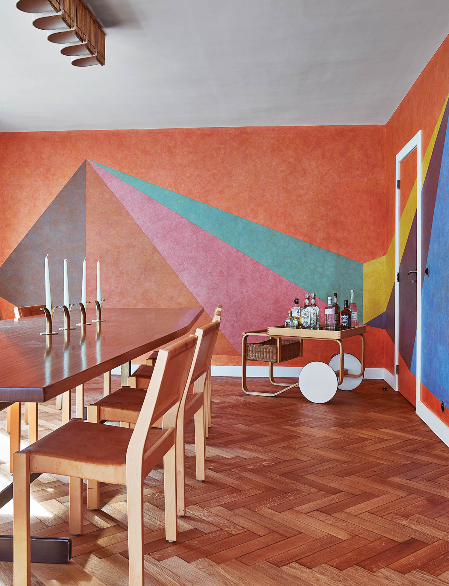 colorful, conceptual artwork on the wall of a dining room