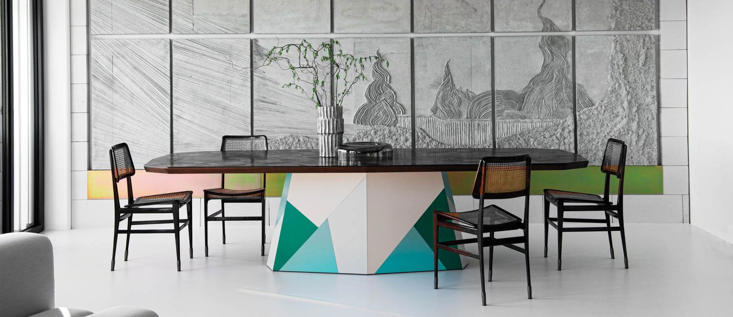 Joaquim Tenreiro chairs furnish the dining area, presided over by Luca Monterastelli’s site-specific concrete bas-relief.