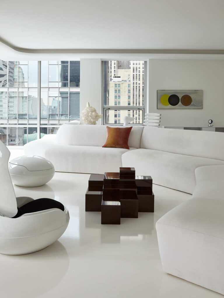 a white sectional in the living room of an apartment in the Museum of Modern Art complex