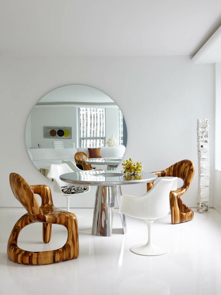 wood chairs and Tulip chairs surround a dining table