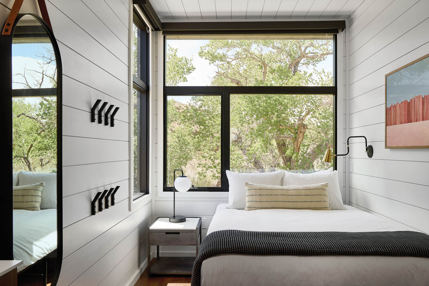 a guest room at AutoCamp Zion with white-painted wood walls