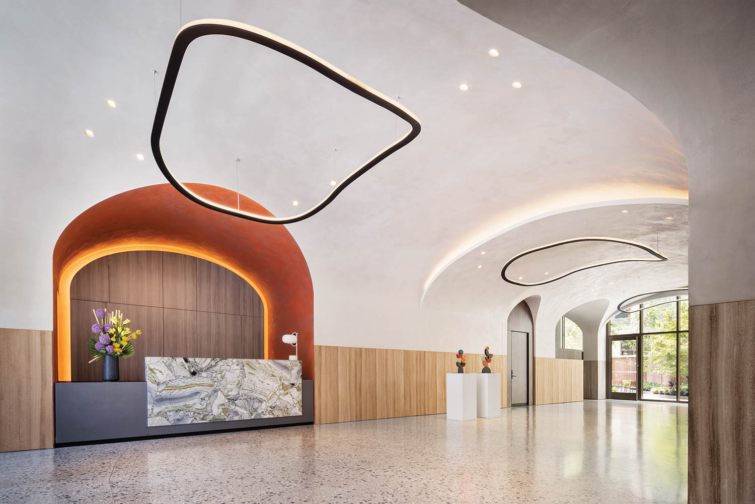 an expansive lobby with curved white ceilings