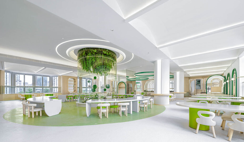 An open classroom with an installation of greenery on the ceiling