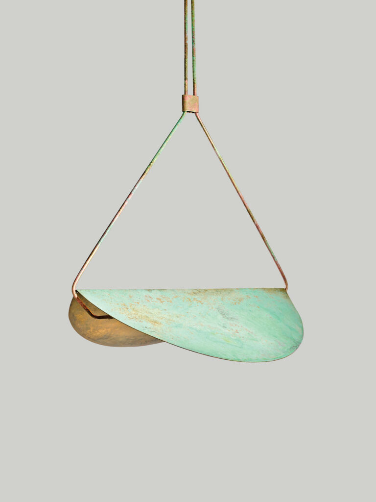 a saddle-shaped light fixture with a teal coating