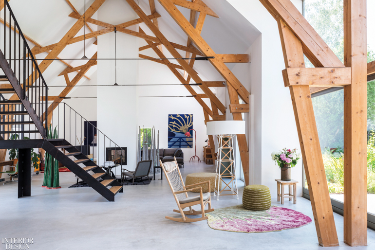 A living area with wooden beams that create an upward structure toward the ceiling. 
