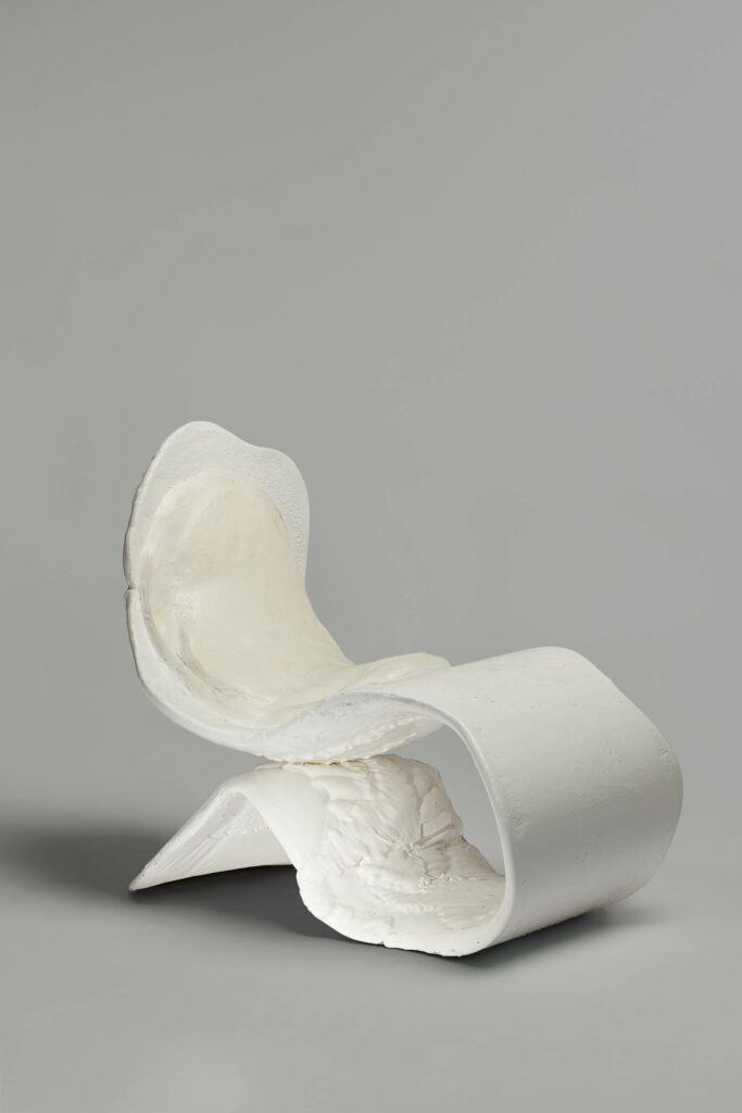 a white textural chair by Louis Durot
