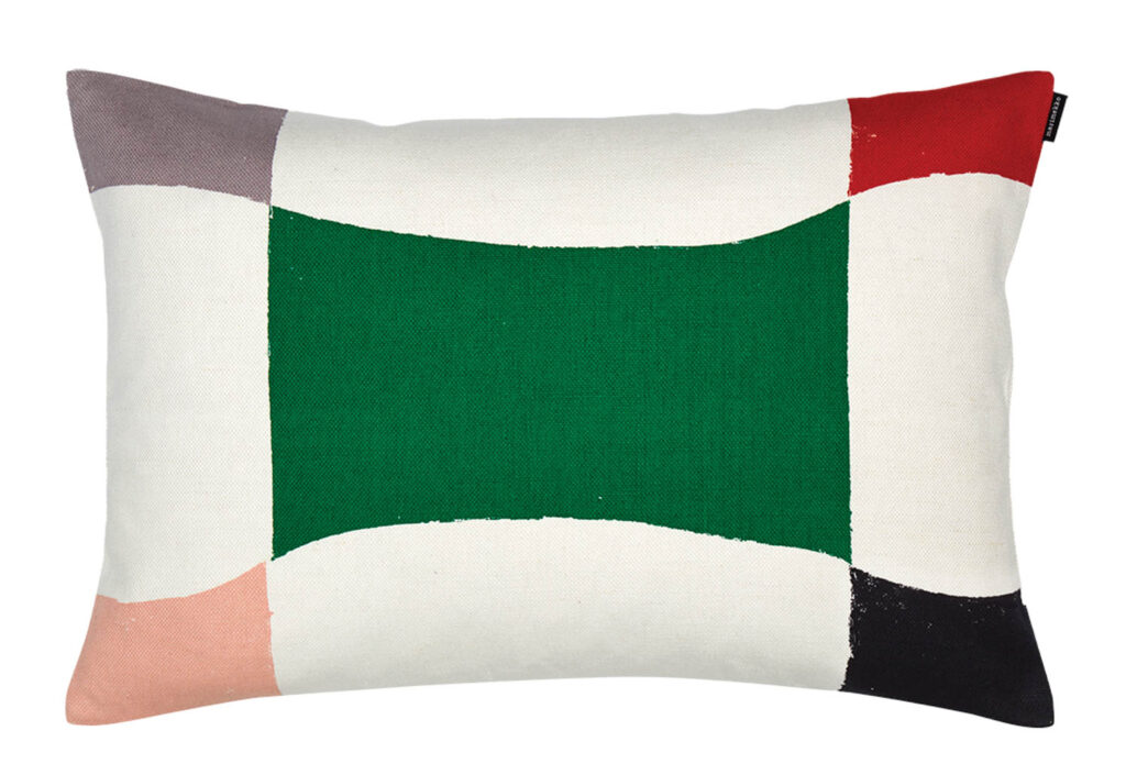 a pillow with a green rectangle at center and diamond color blocks in each corner