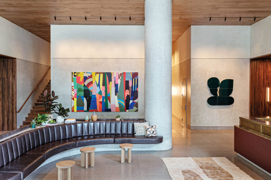 the lobby features a black leather couch and bold artwork