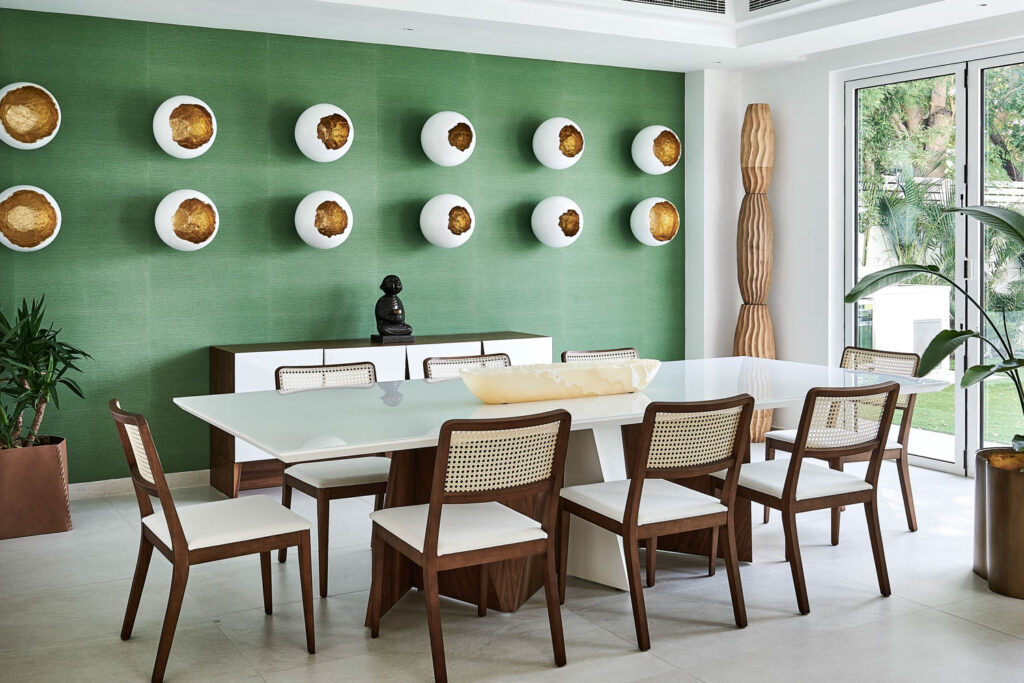 a rectangular dining table near a green accent wall