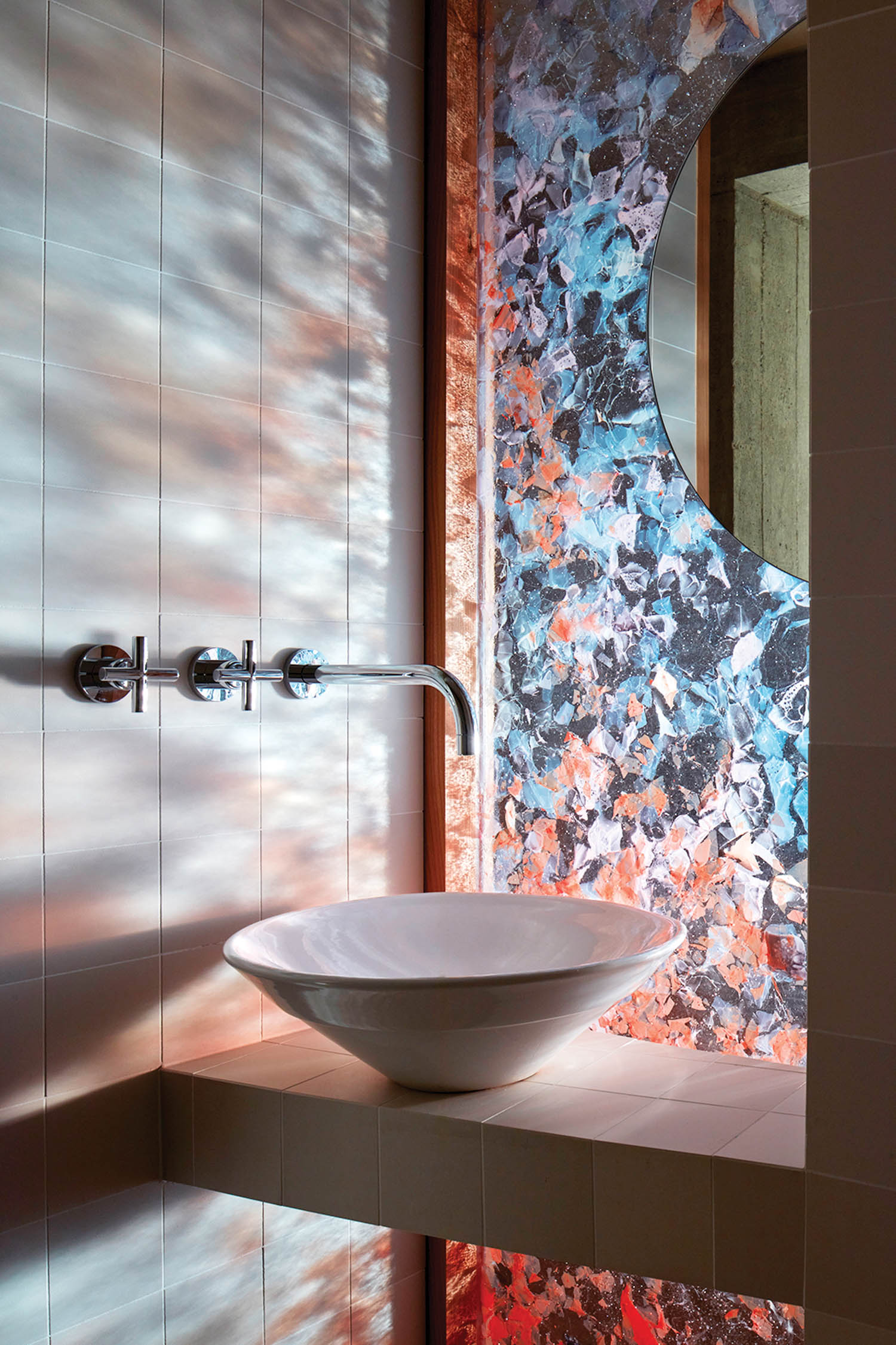 light filters into a stained glass window in a home bathroom