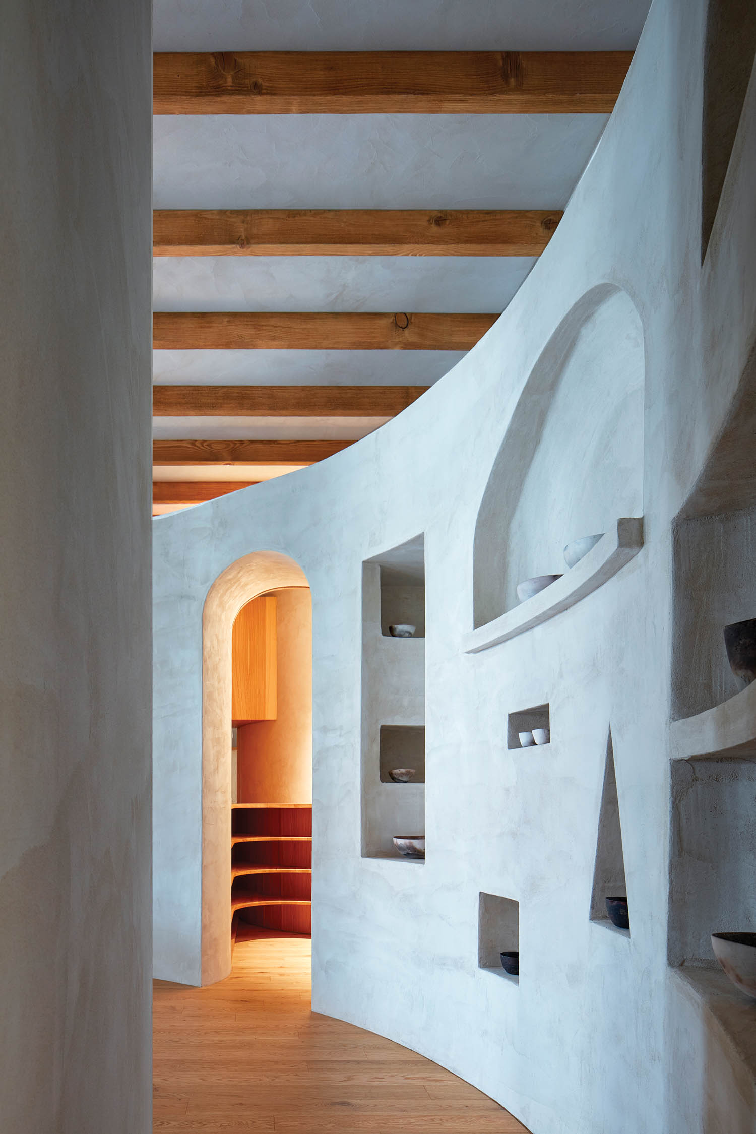 geometric shapes are cut into an interior wall in this Prague home