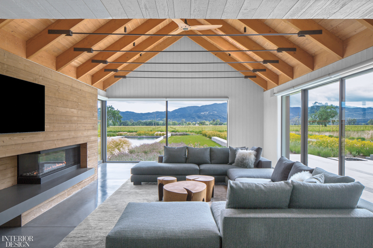 A vaulted ceiling created a dramatic finish to this living room with floor-to-ceiling windows and mountain views