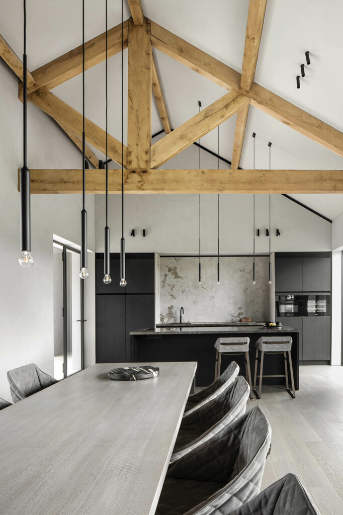 a kitchen with wood beams and a gray table