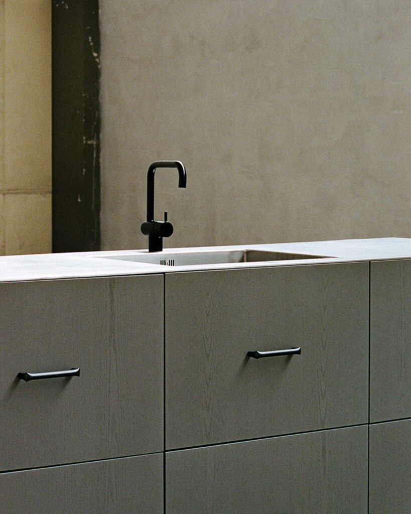 a black faucet on a gray counter