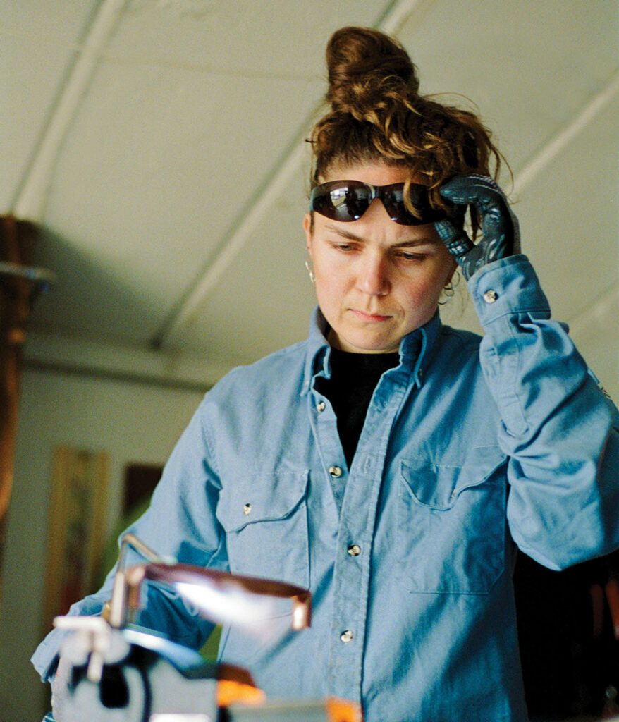 a woman in a blue denim shirt looking at a product