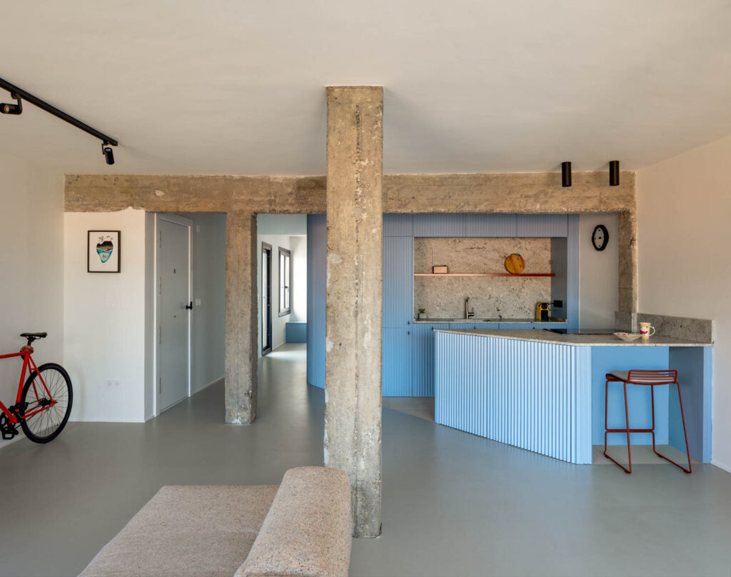 A blue kitchen with wooden beams