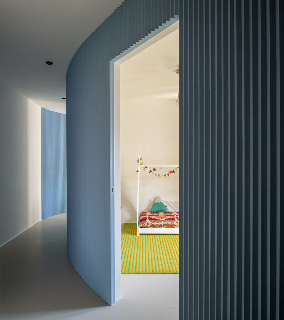 The blue wall opens to the child's room