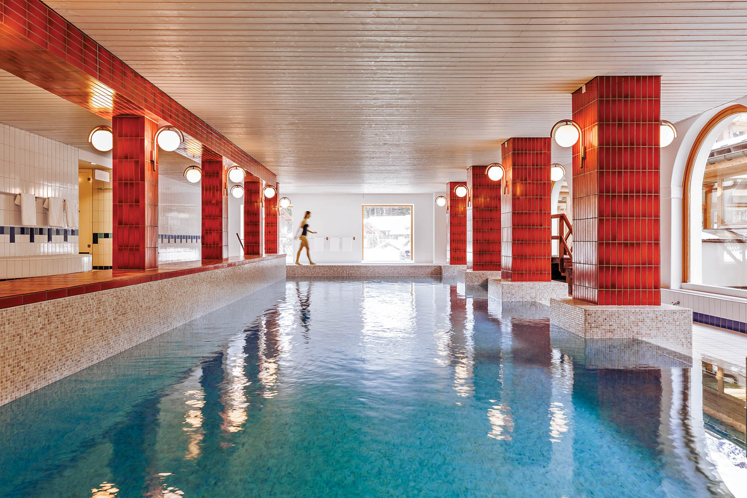 a resort's indoor pool with red tile columns poking out