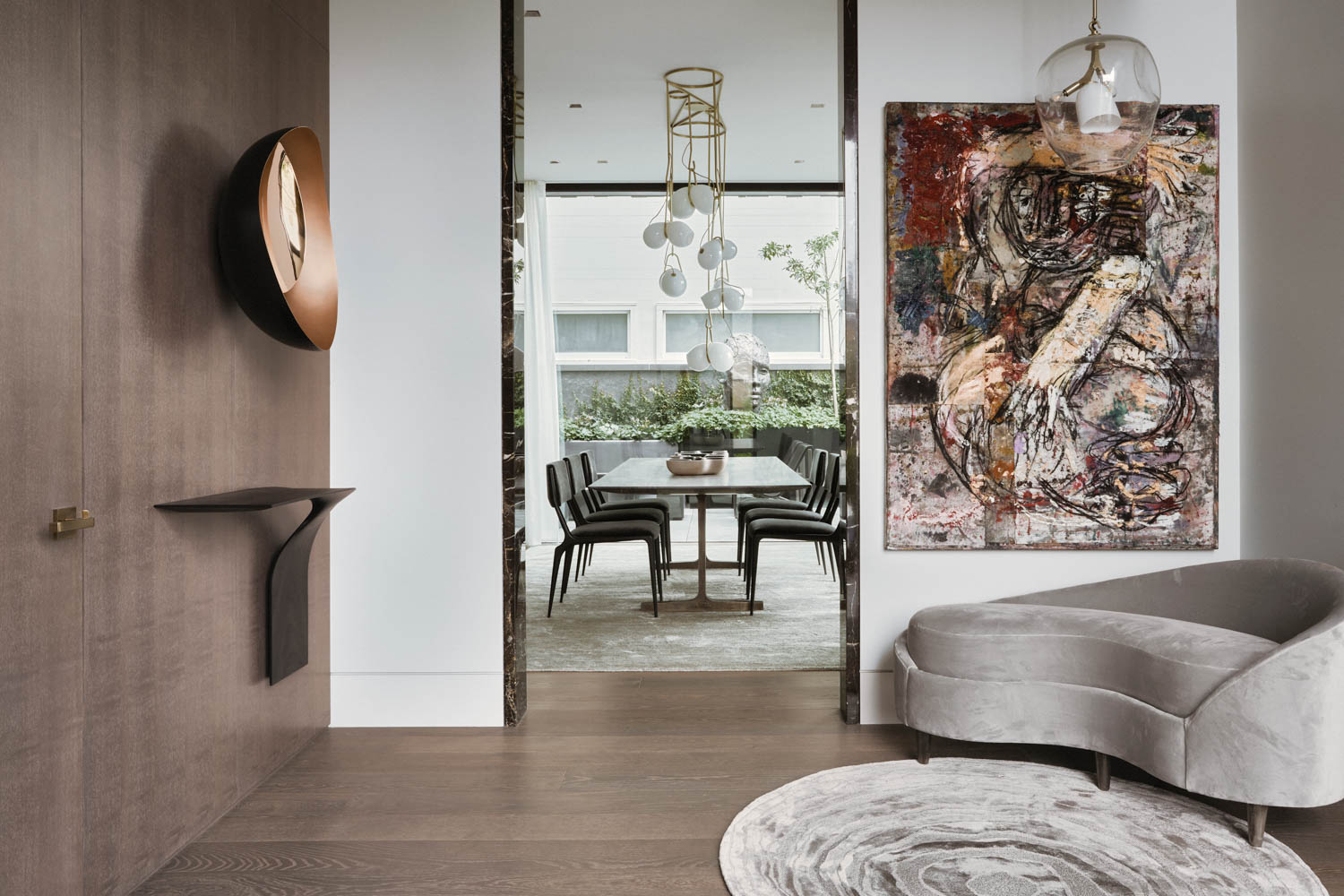 an abstract painting hangs above a grey chaise in a San Francisco home