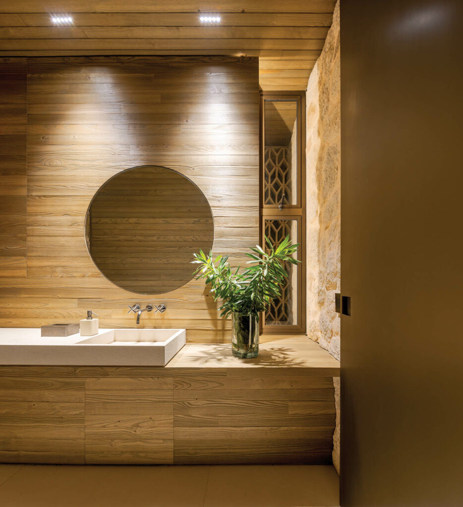 a powder room appointed in pine and Moledo