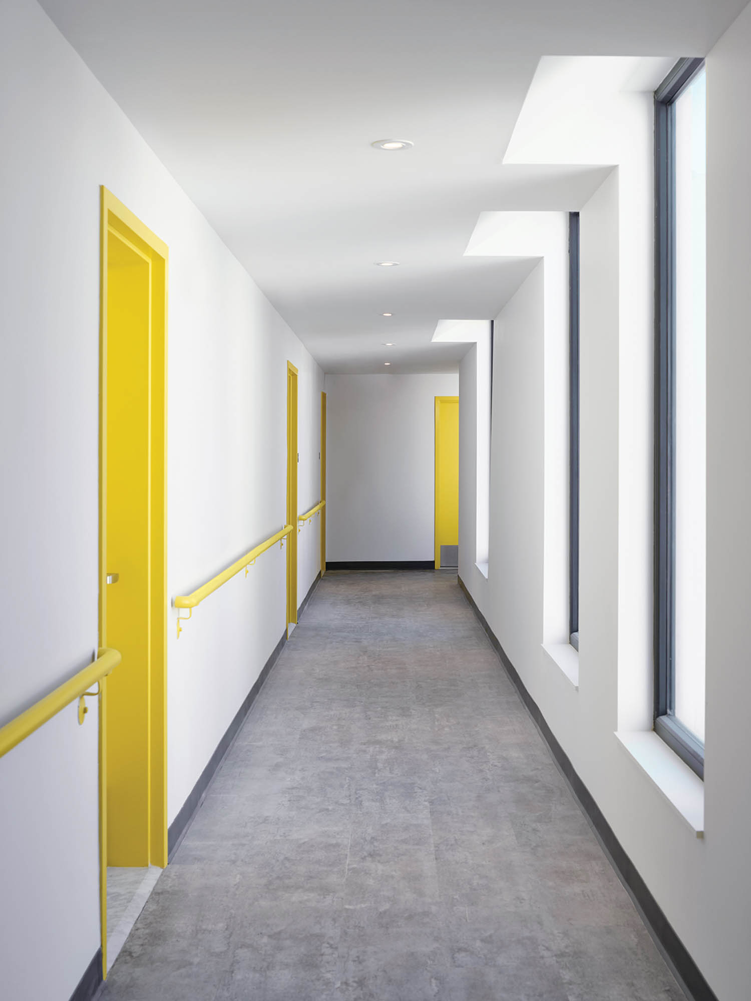 a white wall with a yellow door