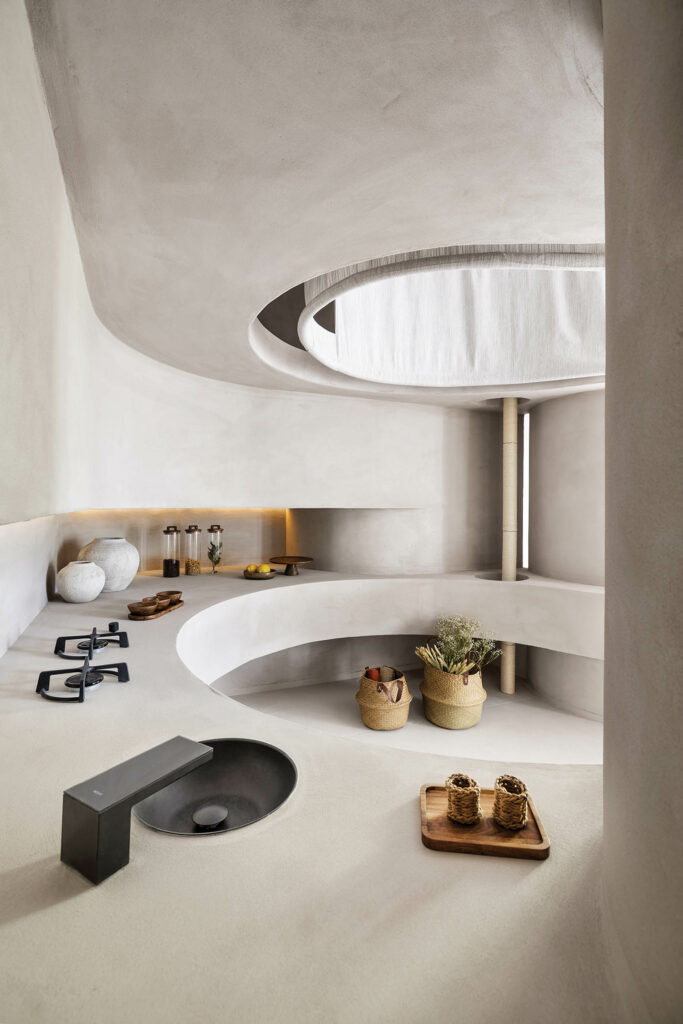 a kitchen curves in a u-shape with minimalist fixtures