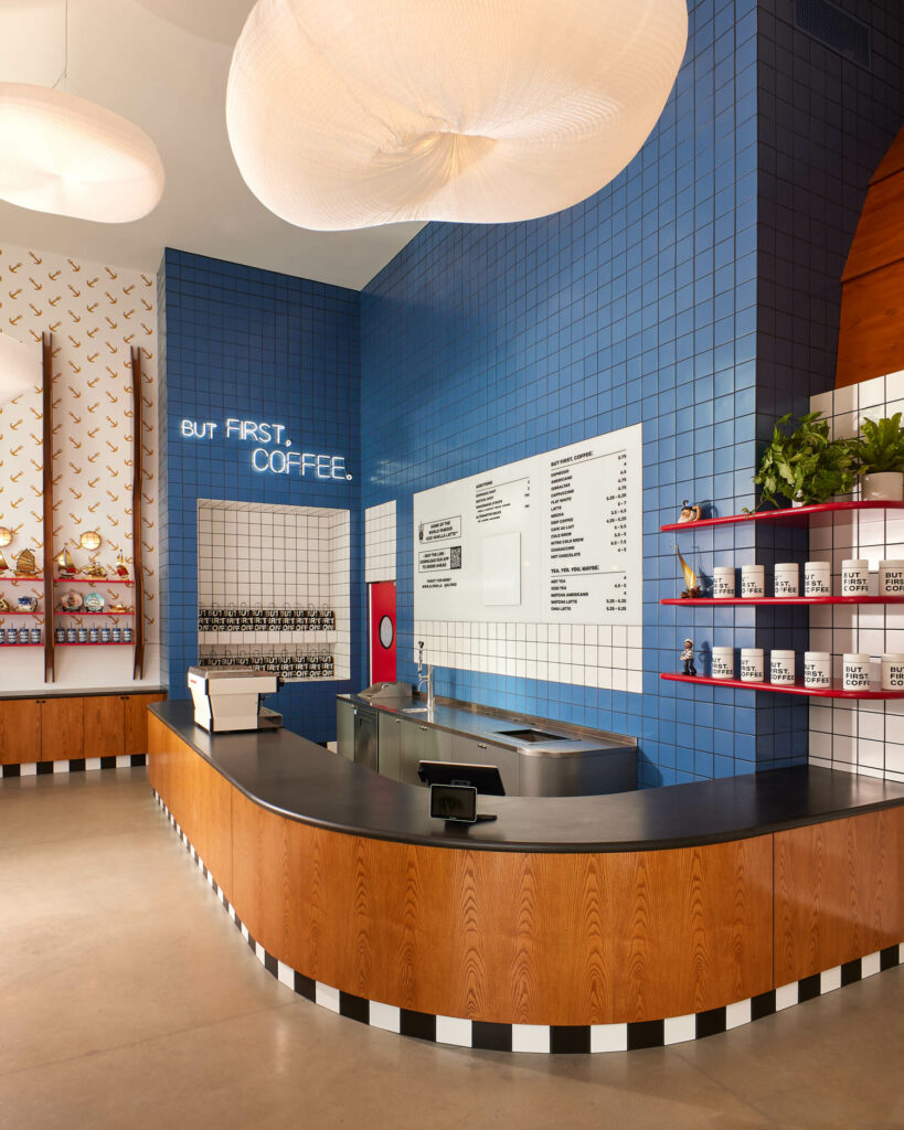 a curving counter in front of a blue tile wall in Alfred Coffee