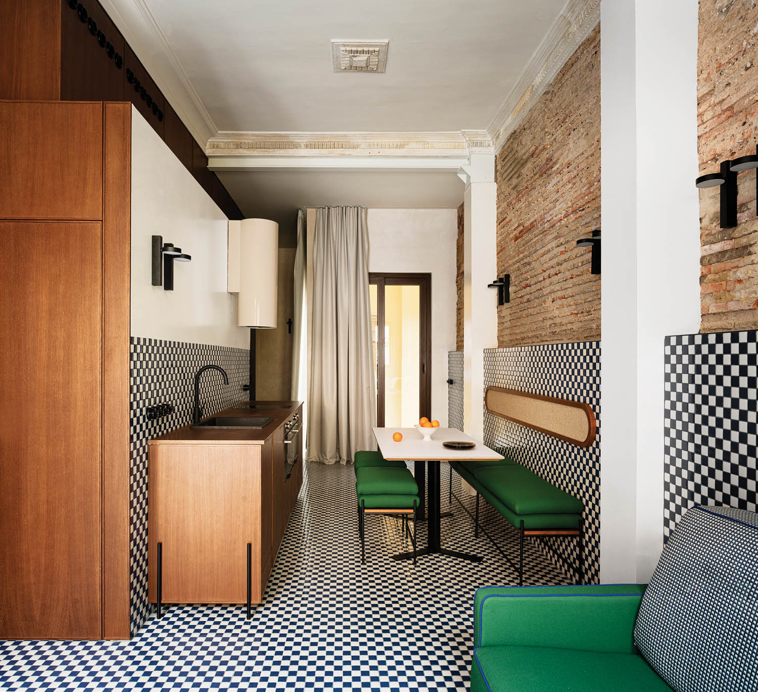 emerald furniture pops against blue and white checkerboard tiles