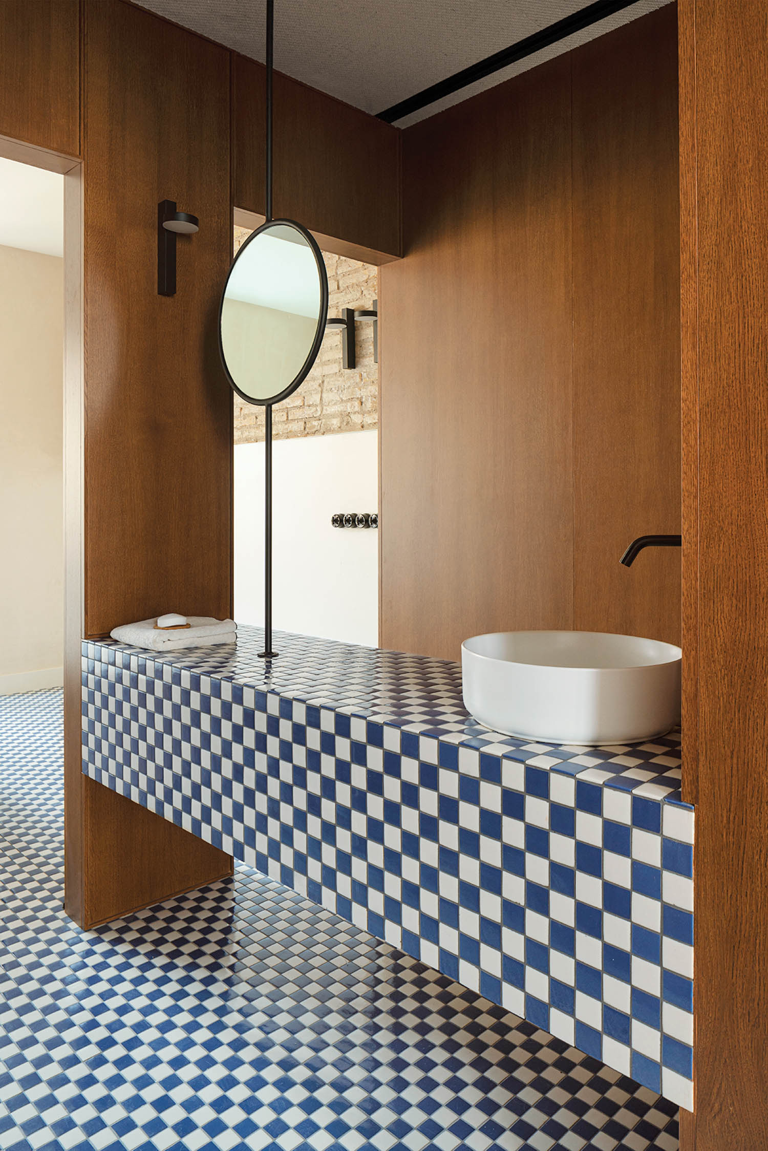 blue and white checkerboard tiles on the floor and the counter of this bathroom