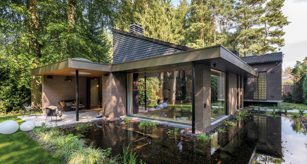 Exterior of a home with glass walls in the woods