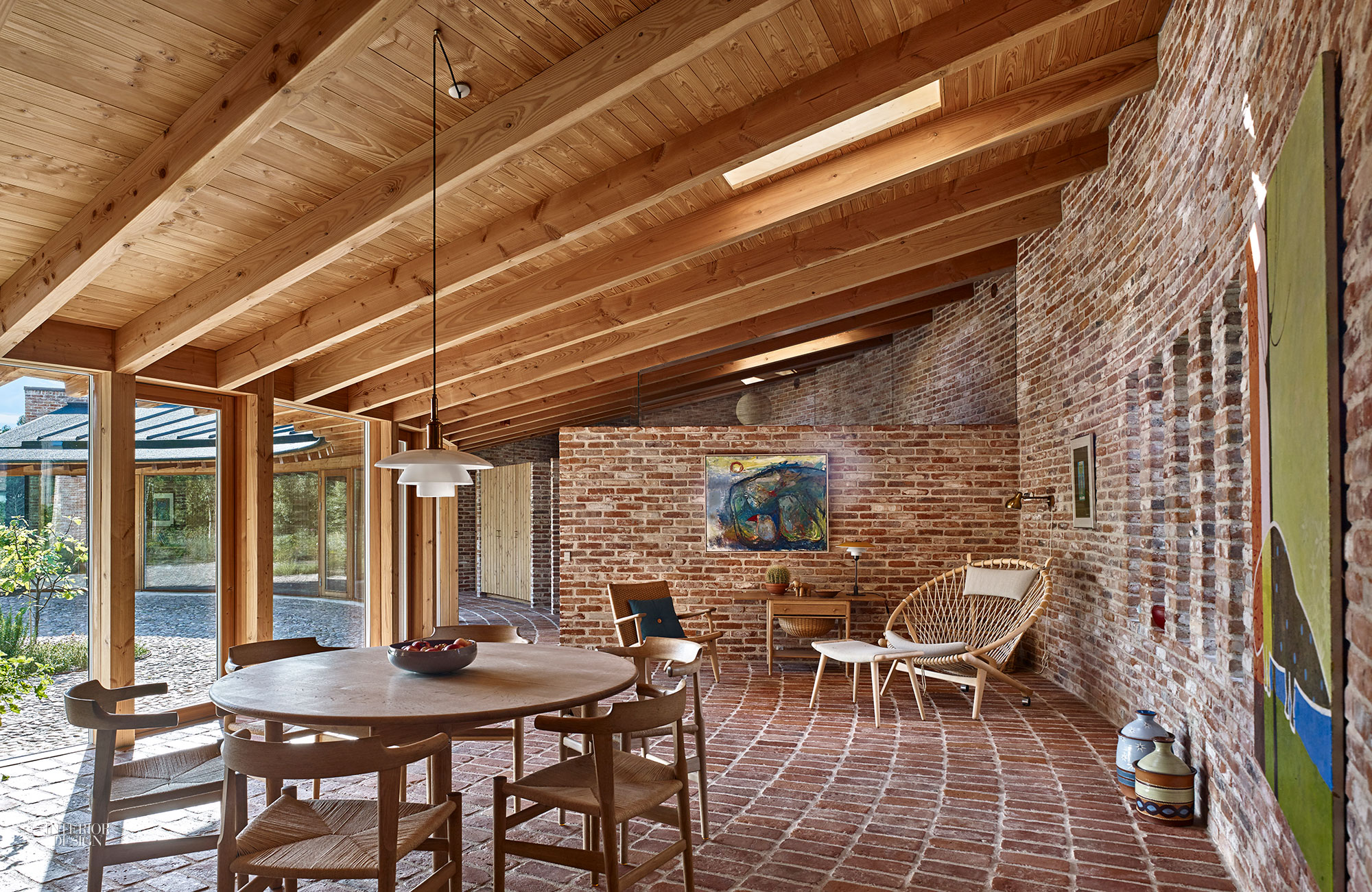 Wooden beams overhead in this airy patio add to the charm